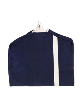 Navy canvas garment bag featuring a full-length zipper, reinforced hanger opening, carrying handle, and natural contrast trim.