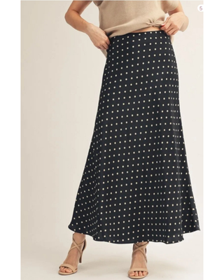 Side view of the black Alena Polka Dot Satin Maxi Skirt showing its sleek, full-length silhouette.