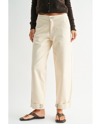 Women's cream high-rise wide leg jeans with cropped ankle length and double-button cuff detail, styled with a black cardigan and sandals.