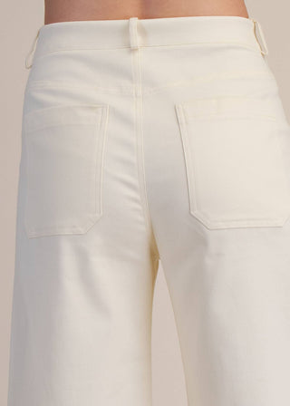 Close-up of white pants back pocket 