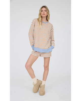 Women’s camel and cream horizontal striped knit lounge shorts with a light blue ribbed waistband, cream drawstring, and side pockets.