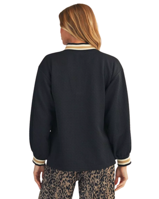 Women’s black textured V-neck top with cream and tan striped neckline, long balloon sleeves, and coordinating striped cuffs.