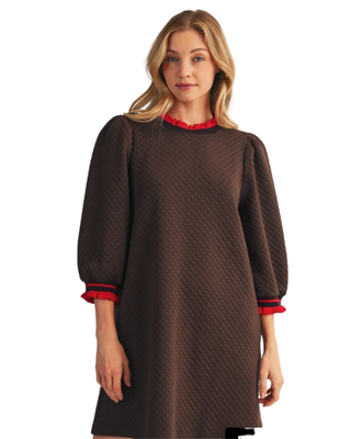 Women’s chocolate brown quilted shift dress with 3/4 puff sleeves and red ruffle trim at the neckline and cuffs.