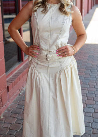 Women's Devi Buckle Poplin midi skirt in cream with a high-rise waist, double-buckle belt, A-line silhouette, and side pockets.