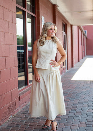 Women's Devi Buckle Poplin midi skirt in cream with a high-rise waist, double-buckle belt, A-line silhouette, and side pockets.