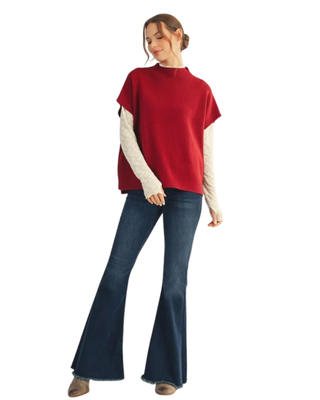 Women’s burgundy knit mock neck sweater with short sleeves, relaxed oversized silhouette, side slits and high-low hem.