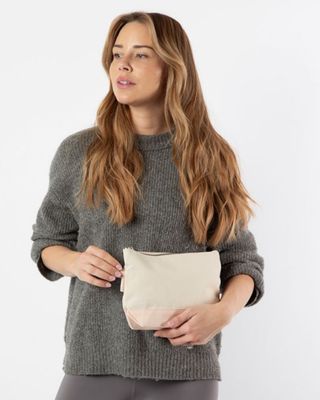 Canvas Makeup Bag in Powder Pink featuring a zip-top closure, durable heavyweight canvas, and compact design for organizing cosmetics and travel essentials.