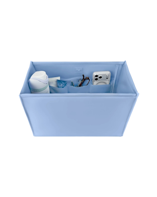 Light blue Case-Mate tote organizer insert with multiple interior pockets holding a phone, sunglasses, water bottle, and everyday essentials.