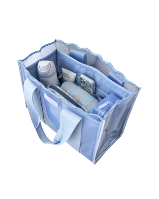 Light blue Case-Mate tote organizer insert with multiple interior pockets holding a phone, sunglasses, water bottle, and everyday essentials.