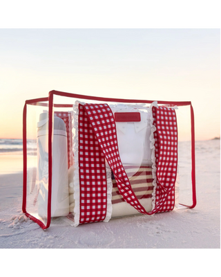Clear jelly tote bag with red and white gingham handles, white ruffle trim, red edging, and detachable gingham phone pouch.