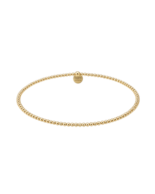 A delicate gold beaded chain necklace with a small round brand tag, displayed on a clean white background.