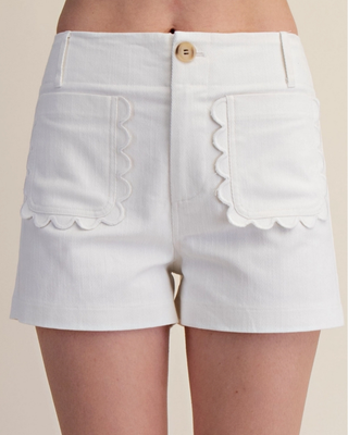 Front view of the white Emerson High-Waisted Shorts featuring scalloped patch pockets, belt loops, and a button closure.