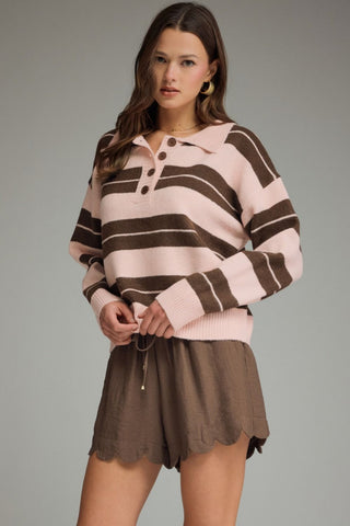 Women's blush pink and mocha brown striped knit sweater featuring a collared button neckline, relaxed fit, and rugby-inspired design.