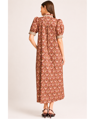 Rust and blush floral print midi dress with puff sleeves, ruffled neckline, gingham trim, button-front detail and side pockets.
