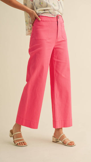 Woman wearing wide legged cropped bright pink pants