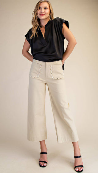 Woman wearing wide leg cropped bottoms with scallop pockets