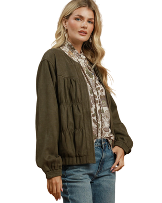 Women’s olive green puff sleeve jacket with gathered front detailing, long sleeves, elasticized cuffs and hem, and relaxed fit.