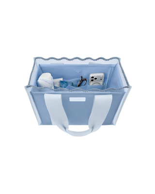 Light blue Case-Mate tote organizer insert with multiple interior pockets holding a phone, sunglasses, water bottle, and everyday essentials.