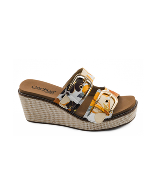 Manifest floral double buckle wedge sandal featuring a colorful floral print upper, gold buckle hardware, woven raffia wedge, and cushioned footbed.