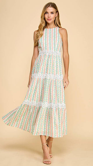 Woman wearing a sleeveless, patterned dress on a beige background