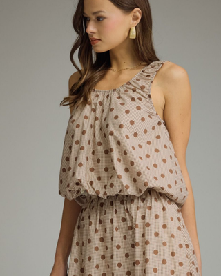 Women's sleeveless mocha polka dot bubble hem blouse with a round neckline and relaxed fit in a lightweight woven fabric.
