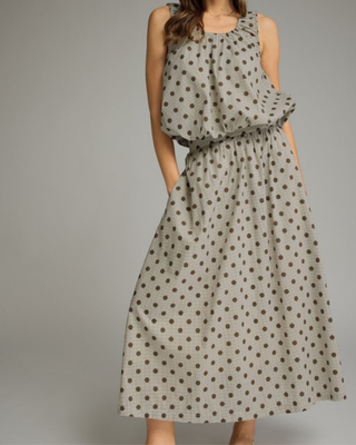 Women's mocha polka dot A-line midi skirt with a high-rise waistband and flowy silhouette in a lightweight woven fabric, styled for an elegant boutique look.