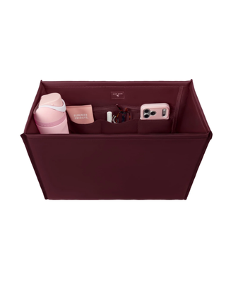 Mulberry tote bag organizer insert with multiple interior pockets holding a water bottle, phone, sunglasses, cosmetics, and everyday essentials.