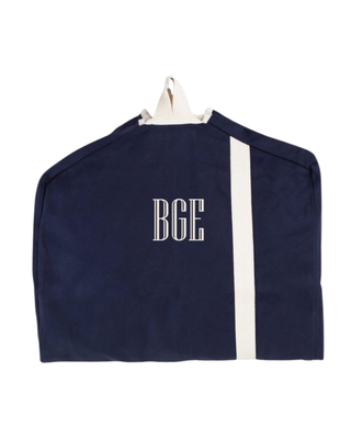 Navy canvas garment bag featuring a full-length zipper, reinforced hanger opening, carrying handle, and natural contrast trim.