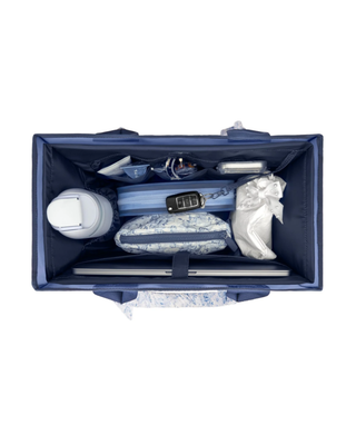 Navy blue tote bag organizer insert with multiple interior pockets holding a water bottle, phone, sunglasses, cosmetics, and everyday essentials.