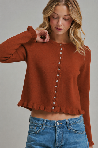 Women's rust button-front knit cardigan with long sleeves, ruffle-trim cuffs and hem, crew neckline and slightly cropped silhouette.
