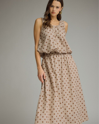 Women's sleeveless mocha polka dot bubble hem blouse with a round neckline and relaxed fit in a lightweight woven fabric.