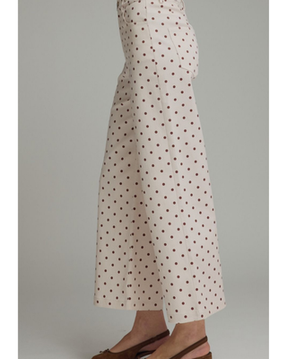 Women's ivory wide-leg pants with a mocha brown polka dot print, high-rise waist, and relaxed silhouette, styled for a chic boutique outfit.