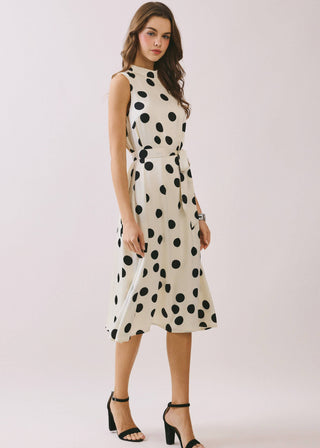 Woman wearing a polka dot dress on a white background