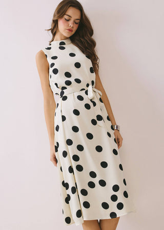 Woman wearing a white dress with black polka dots 