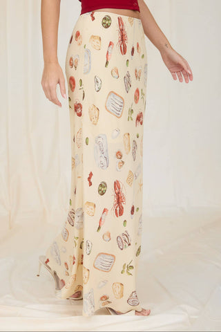 Model wearing the Alena Portofino Slip On Midi Skirt featuring a Mediterranean-inspired seafood and coastal food print with a flattering slip-on midi silhouette.