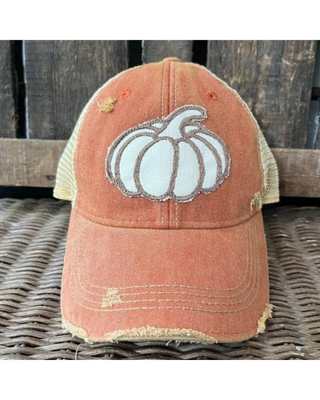 Burnt orange distressed mesh-back trucker hat featuring an embroidered white pumpkin patch and curved brim.