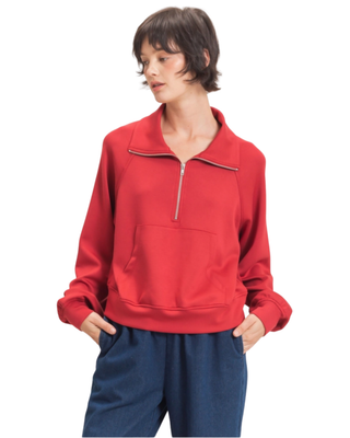 Women’s red half-zip pullover with fold-over collar, long sleeves, kangaroo front pocket and relaxed fit.