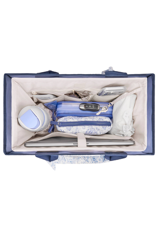 Overhead view of the Case-Mate French Vanilla Jelly Tote Organizer filled with daily essentials inside a navy tote.