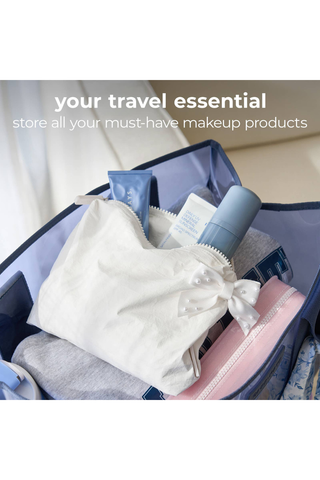 Case-Mate Ivory Pearl Bow Crinkle Makeup Bag holding makeup, toiletries, and travel essentials.