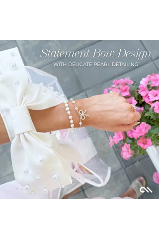 Close-up of the Case-Mate Ivory Pearl Bow Jelly Tote strap featuring a statement bow with delicate pearl detailing.