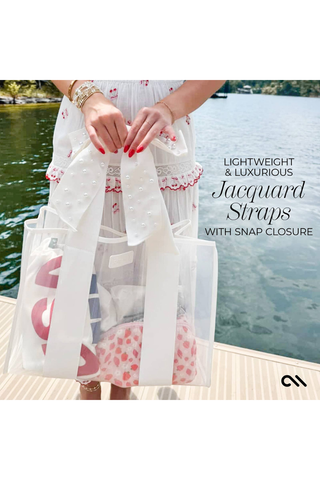 Case-Mate Ivory Pearl Bow Jelly Tote featuring extra-wide jacquard straps, pearl bow detail, and covered snap closure.