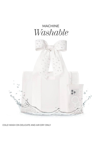 Machine-washable Case-Mate Ivory Pearl Bow Jelly Tote with phone pouch, suitable for a cold delicate wash and air drying.
