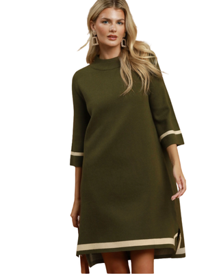 Women’s olive green sweater dress with cream contrast trim, mock neckline, three-quarter sleeves, relaxed fit, and side slits.