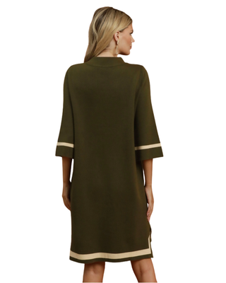 Women’s olive green sweater dress with cream contrast trim, mock neckline, three-quarter sleeves, relaxed fit, and side slits.