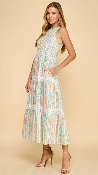 Woman wearing a sleeveless dress with a striped pattern on a beige background