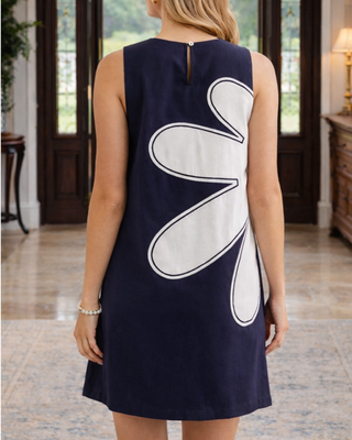 Shannon Coastal Flower Dress in navy with oversized ivory floral appliqué and sleeveless shift silhouette.