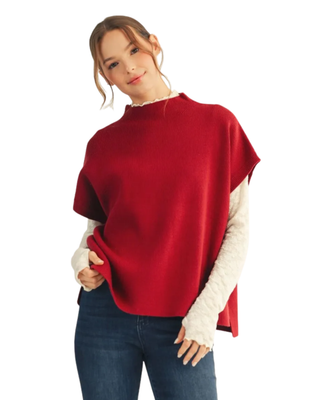 Women’s burgundy knit mock neck sweater with short sleeves, relaxed oversized silhouette, side slits and high-low hem.
