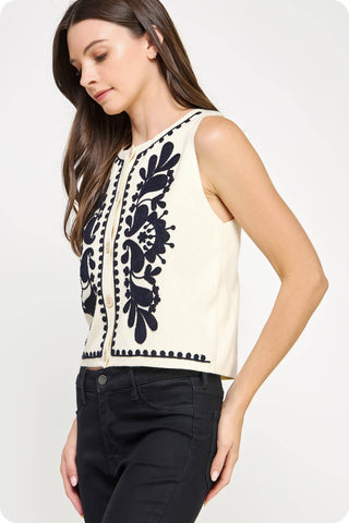 Sleeveless ivory button up knit vest top with black embroidered design