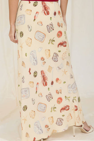 Model wearing the Alena Portofino Slip On Midi Skirt featuring a Mediterranean-inspired seafood and coastal food print with a flattering slip-on midi silhouette.