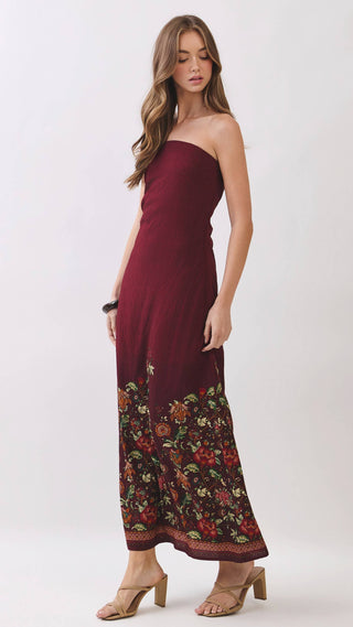 Burgundy strapless maxi dress with floral design on the bottom